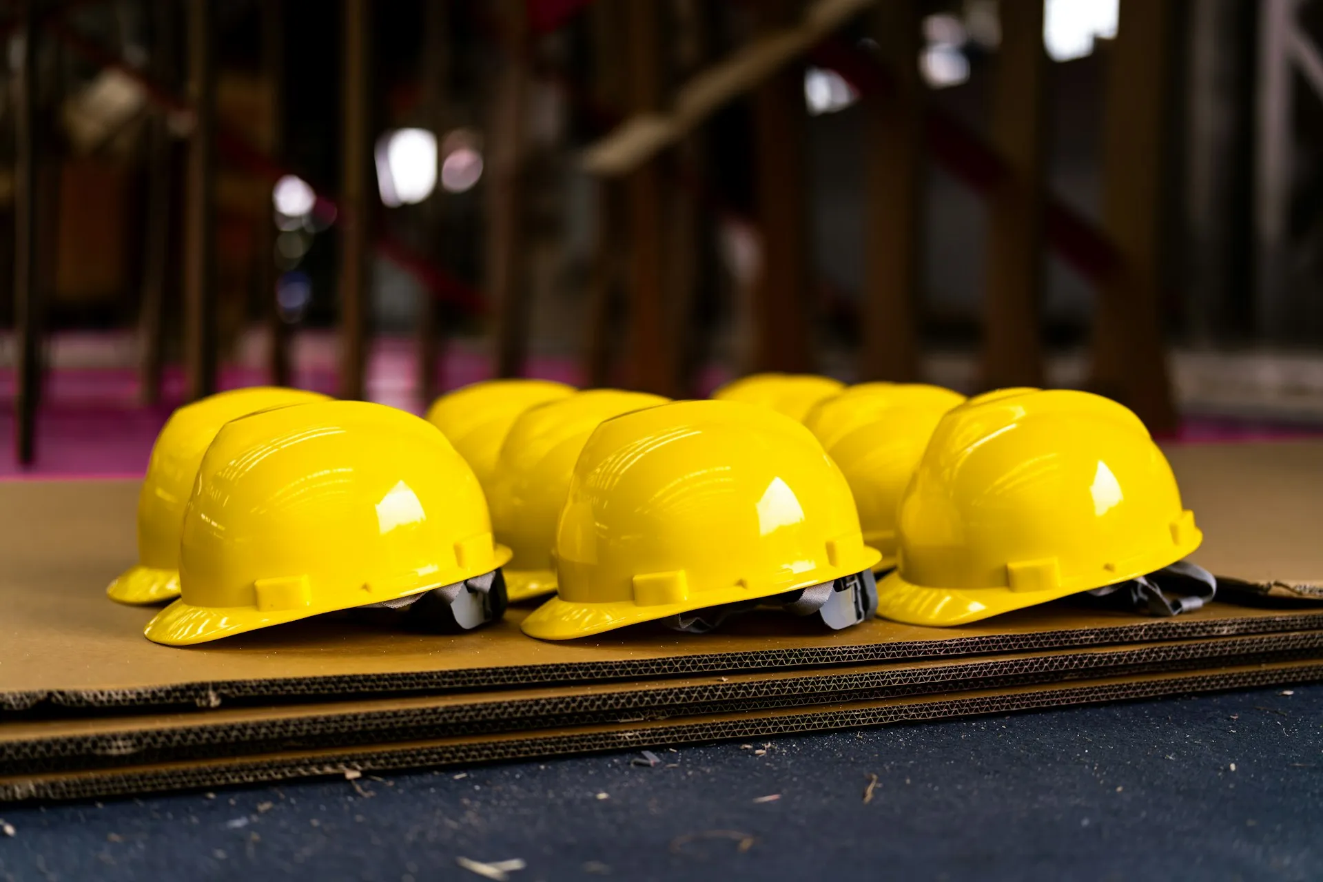 Row of yellow hard hats on a table at a construction site