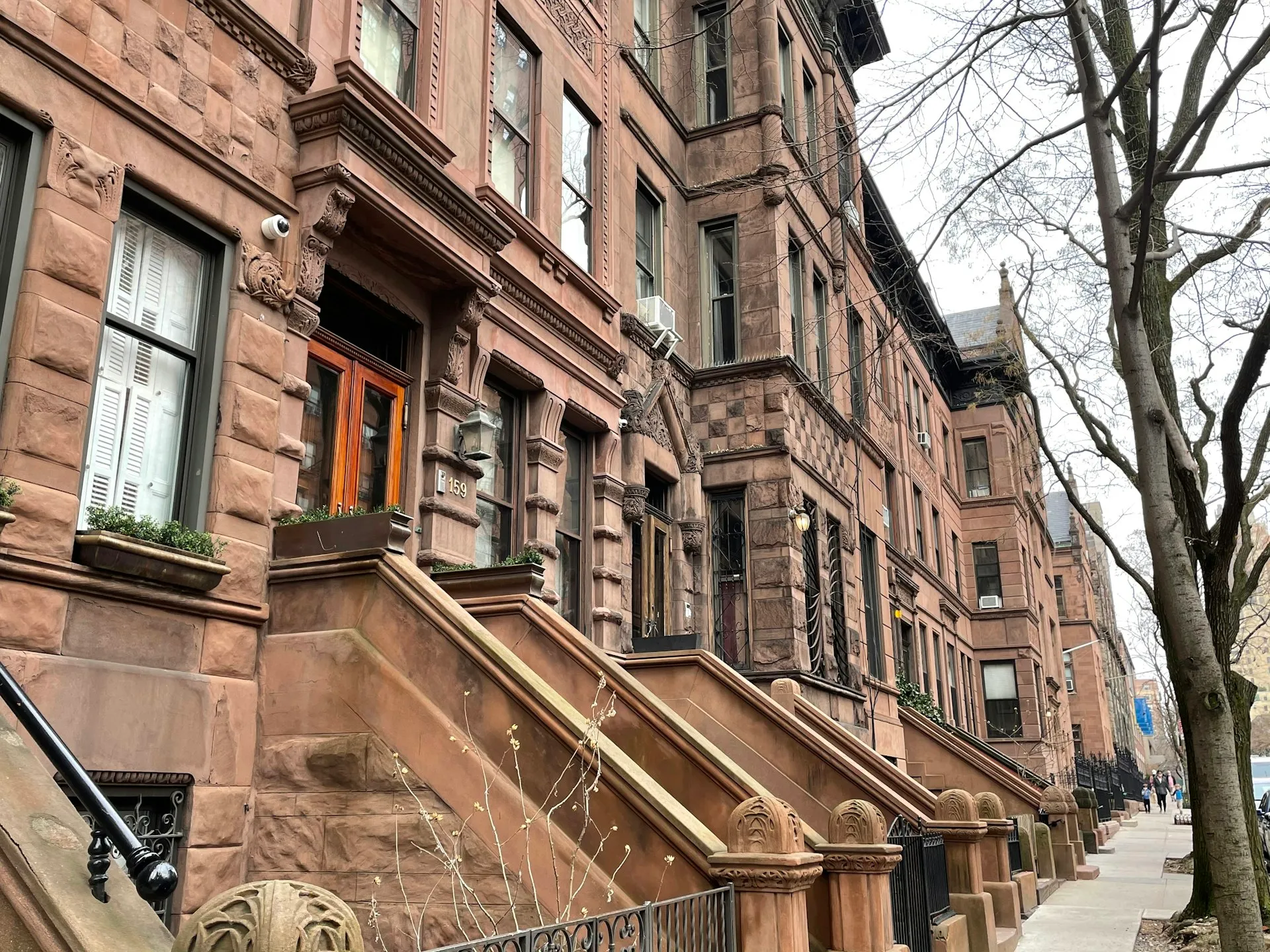 Row of New York brownstone townhouses with stoops