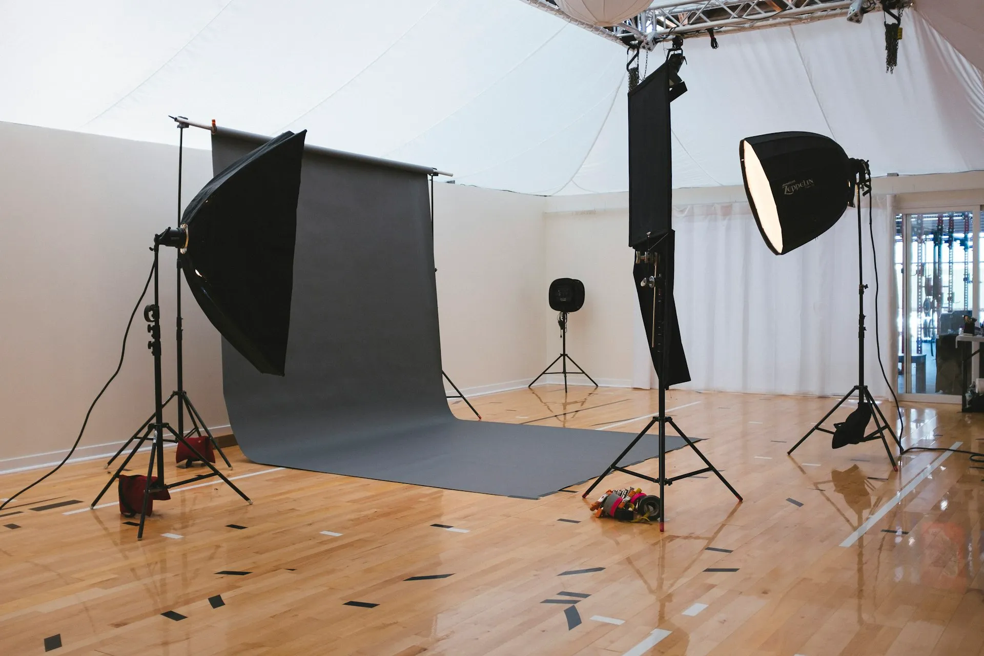 Empty photography studio with lighting stands and a backdrop